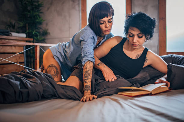 istock Lesbian couple reading book 1196504075