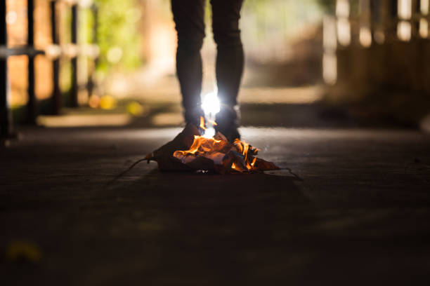 istock A man is stand behind the bonfire. 1196505817