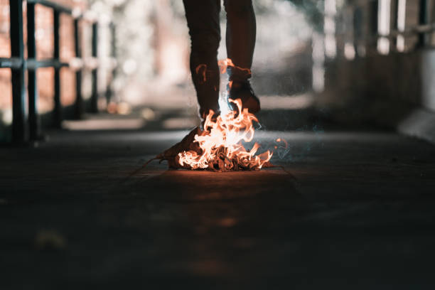 istock A man is stand behind the bonfire. 1196505825