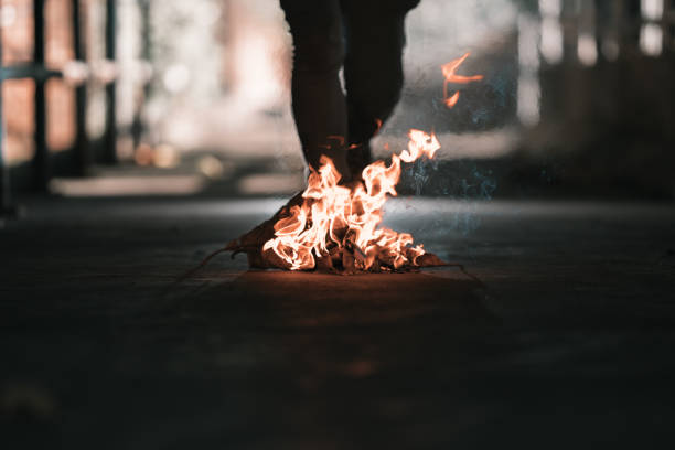 istock A man is stand behind the bonfire. 1196505858