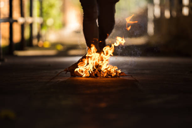 istock A man is stand behind the bonfire. 1196505859