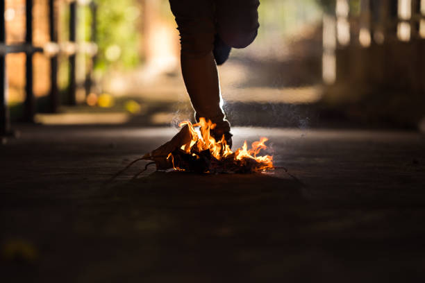 istock A man is stand behind the bonfire. 1196505994