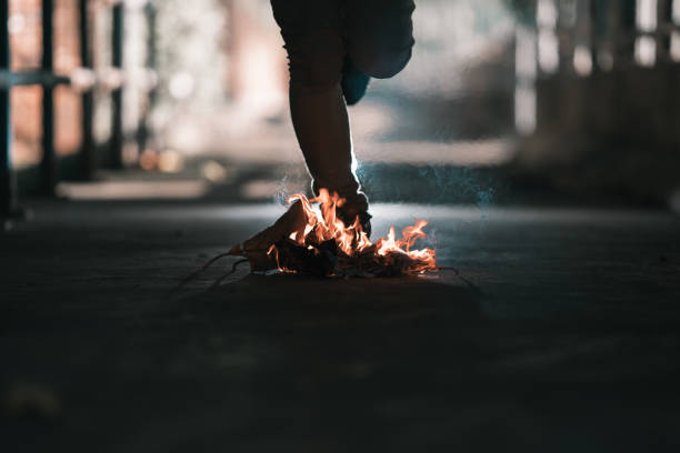 istock A man is stand behind the bonfire. 1196506011