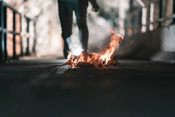 istock A man is stand behind the bonfire. 1196506692