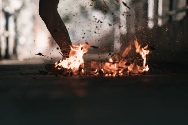 istock A man is kick the bonfire. 1196506838