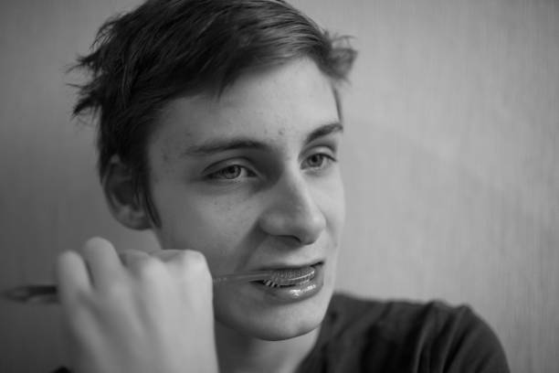 istock Teen boy brushes his teeth with a toothbrush 1196507064
