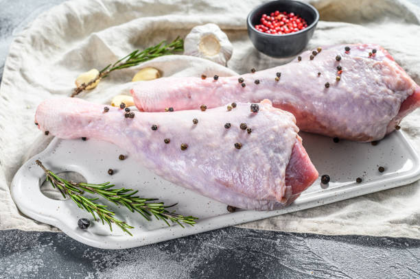 istock Turkey leg with spices on a white cutting Board. Gray background. Top view 1196508897