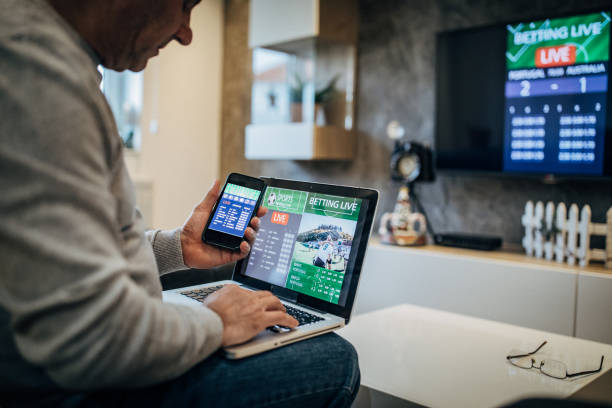 istock Mature man using mobile app for live betting 1196509021