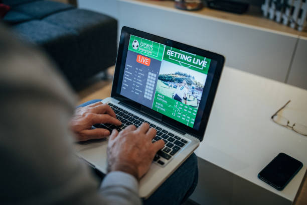 istock Watching football match on computer and betting 1196509262
