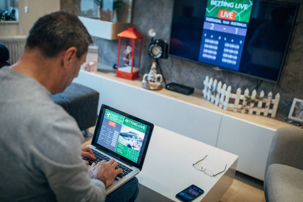istock Watching football match on computer and betting 1196509782