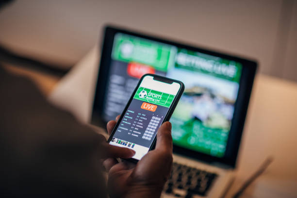 istock Watching football match on computer and betting 1196509910