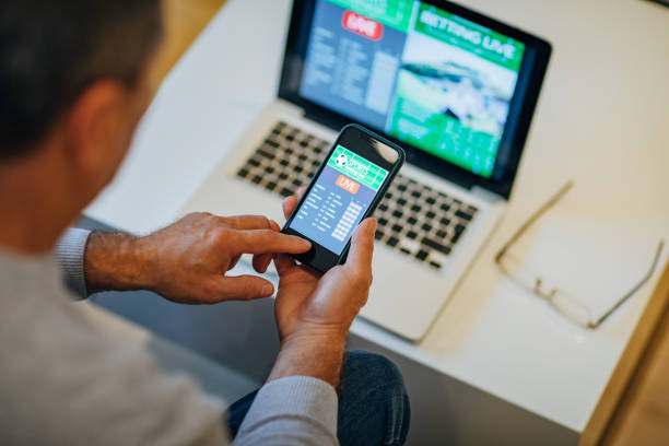 istock Watching football match on computer and betting 1196509961