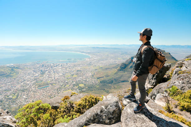 istock a man taking in view on Table Mountain, Cape Town 1196510244