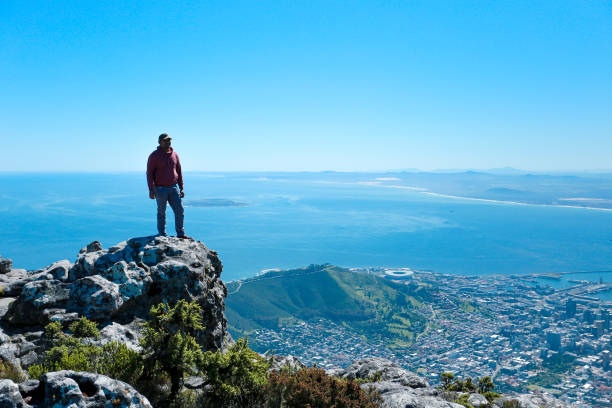 istock a man taking in view on Table Mountain, Cape Town 1196510994