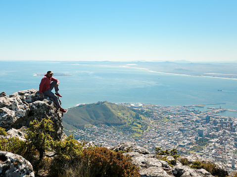 south Africa, Cape Town, man standing looking at the coast during hiking trip to Lion's Head