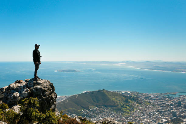 istock a man taking in view on Table Mountain, Cape Town 1196511241