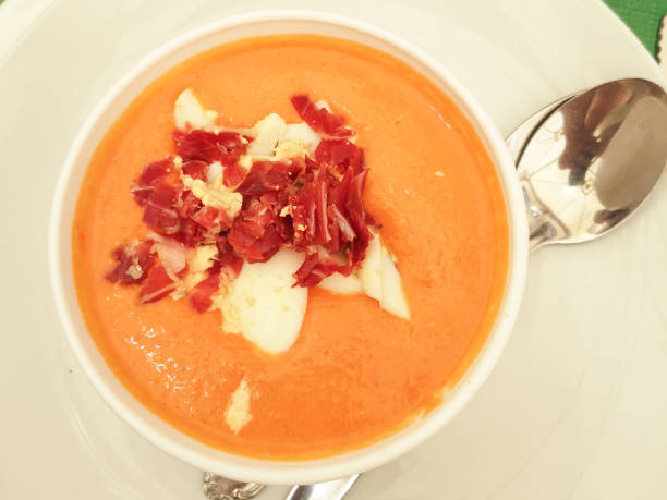 istock Pumpkin soup with bacon and sour cream on a white plate with a tablespoon 1196511259