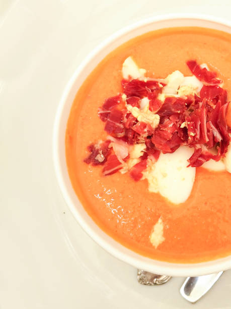 istock Pumpkin soup with bacon and sour cream on a white plate with a tablespoon 1196511269