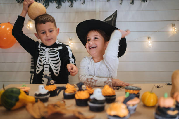istock Playful brother and sister having fun for Halloween 1196512452