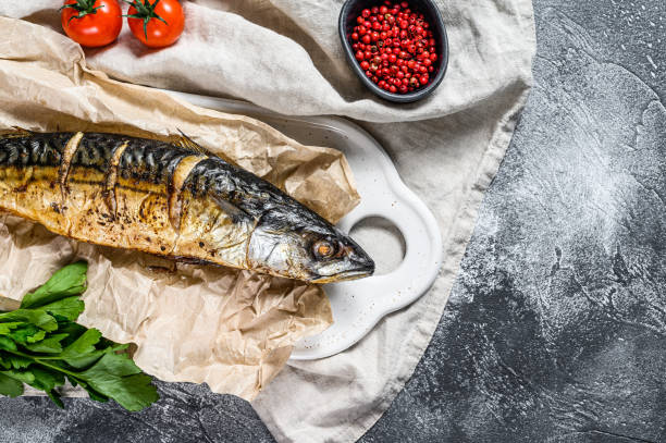 istock smoked mackerel with parsley and cherry tomatoes. Gray background. Top view. Space for text 1196513921