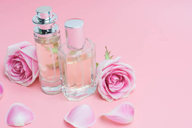 istock Beautiful perfume bottles on pink background 1196515289