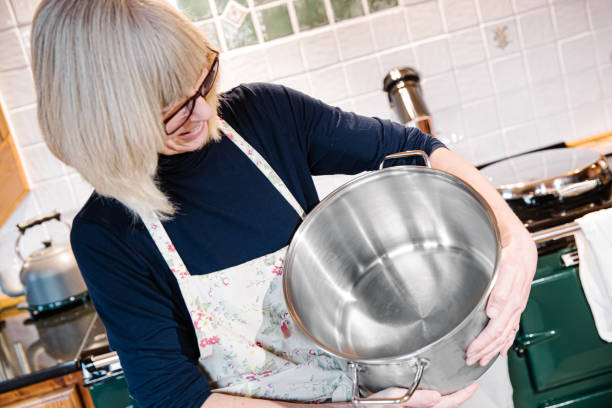 istock Woman in her kitchen with a large stock pot 1196518190