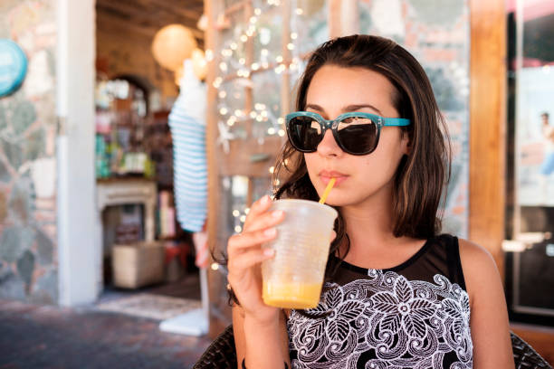 istock Pretty girl sipping a smoothie 1196518334