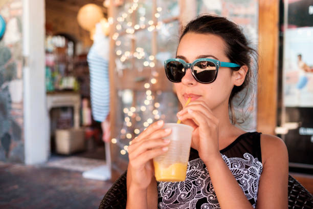 istock Pretty girl sipping a smoothie 1196518340