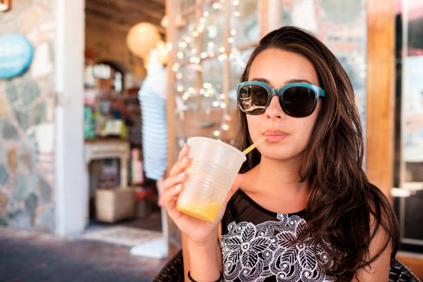 istock Pretty girl sipping a smoothie 1196518359