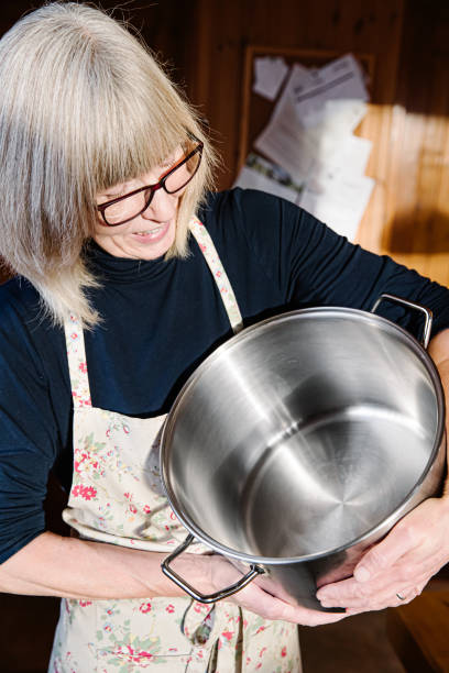 Woman in her kitchen with a large stock pot