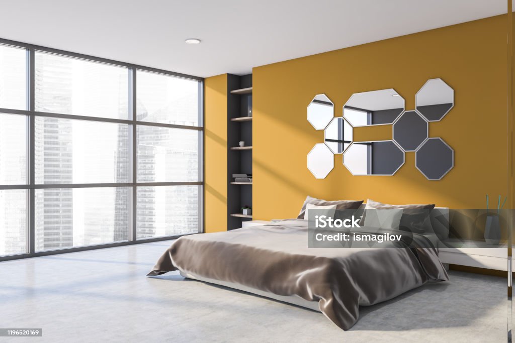 Yellow master bedroom corner with mirrors Corner of panoramic bedroom with gray and yellow walls, concrete floor, king size bed with brown velvet blanket and mirrors above it. 3d rendering Adult Stock Photo