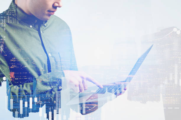 istock Casual man with laptop in city, digital graph 1196521214