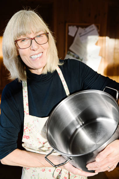 istock Woman in her kitchen with a large stock pot 1196521394