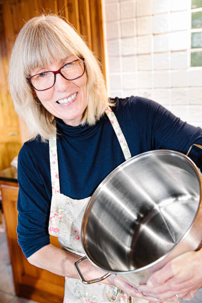 istock Woman in her kitchen with a large stock pot 1196521739