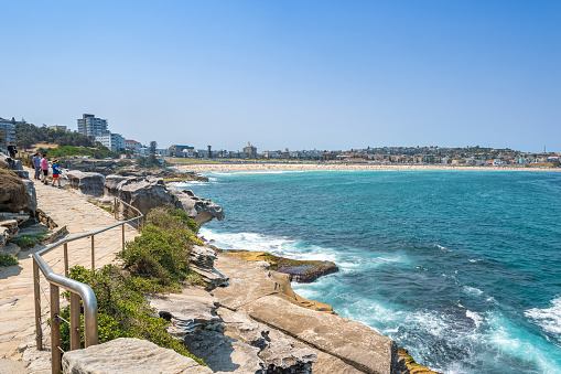 Sydney, Australia - December 28th, 2019: People walking to Waverley Cemetery along the Bondi to Coogee coastal walk. A cliff top coastal walk featuring stunning views, beaches, cliffs, and rock pools.