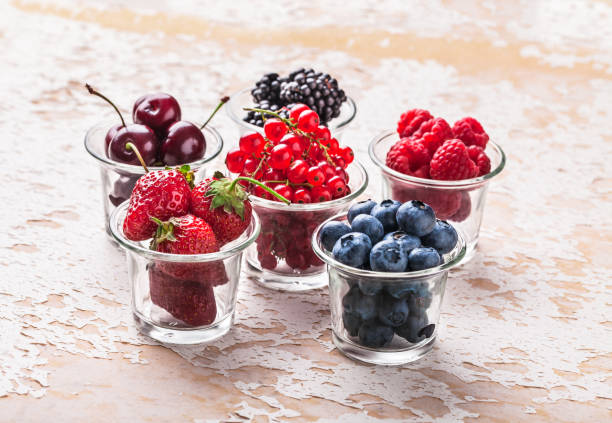 istock Forest fruit colorful arrangement in glass jars on white table 1196526777