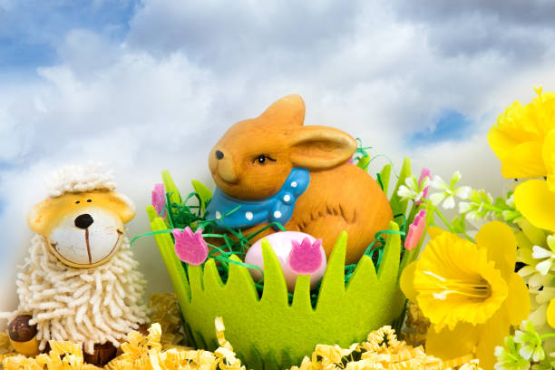 Easter bunny with eggs in a green easter basket, flower decoration and space for text