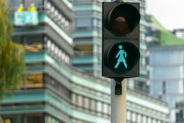 Green pedestrian signal to go. Traffic light female figure shape in Vilnius, Lithuania stock photo