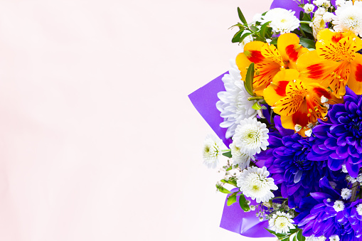Bouquet of wildflowers on Valentine's Day. Bunch of alstroemeria flowers in the classic blue wrapper. Festive bouquet of flowers with copy space. Top view