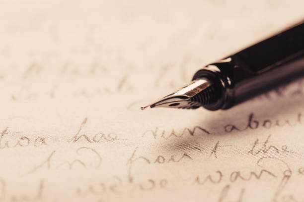 istock fountain pen on paper with ink text closeup 1196535375