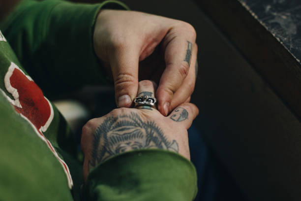 istock Close up of jeweler hand with scull shape ring 1196536389
