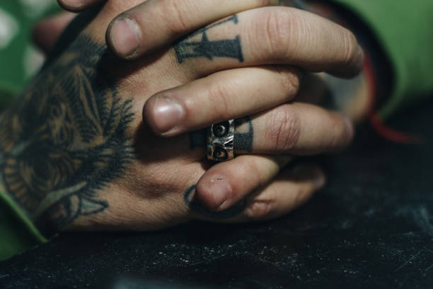 istock Close up of jeweler hand with scull shape ring 1196536429