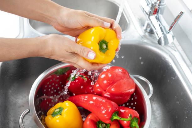istock Peppers Being Washed in a Kitchen Sink 1196536575
