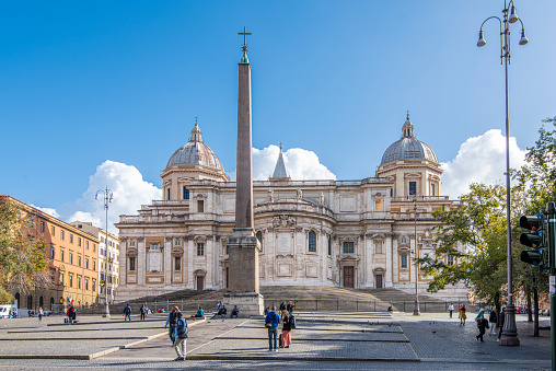 People walking on the square next to the Basilica Santa Maria Maggiore at Rome city, Italy. Located on the hill of Esquilino district, the Basilica is visited daily by lot of pilgrims and tourist and it is an Unesco World Heritage Site.