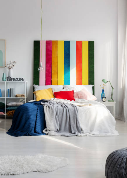 istock Colorful bedroom interior with rainbow colored bedhead 1196542586