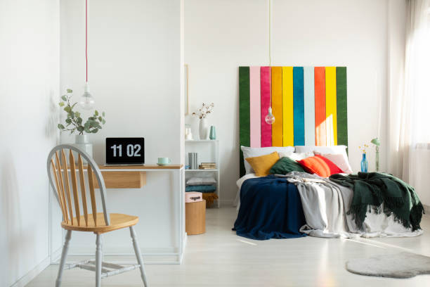 istock Open space bedroom and home office interior with bed and desk 1196542588