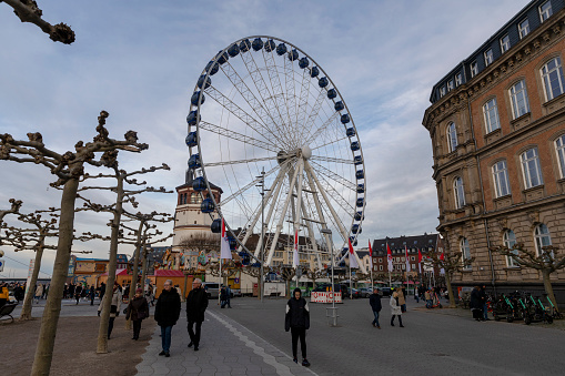 Düsseldorf, Germany - dec 29th 2019: Christmas market is attracting visitors to Düsseldorf old town from all over the world. Ferris wheel is visible to far.