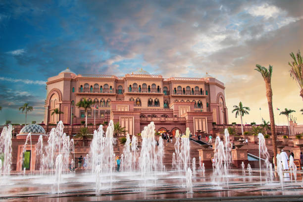 Abu Dhabi, United Arab Emirates - November 1, 2019: Emirates palace in Abu Dhabi reflected on the ground level fountain at sunset