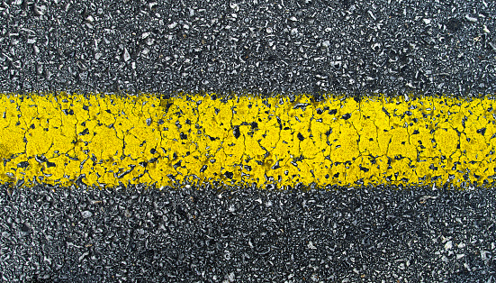 Close up view of yellow road line