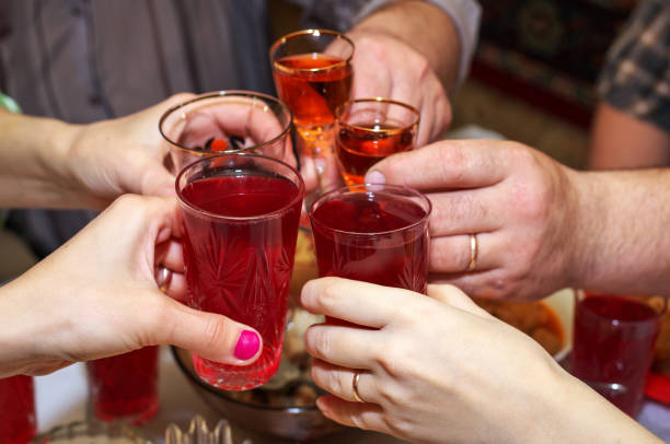 istock People drink at the table, clink glasses. Cheers 1196548738